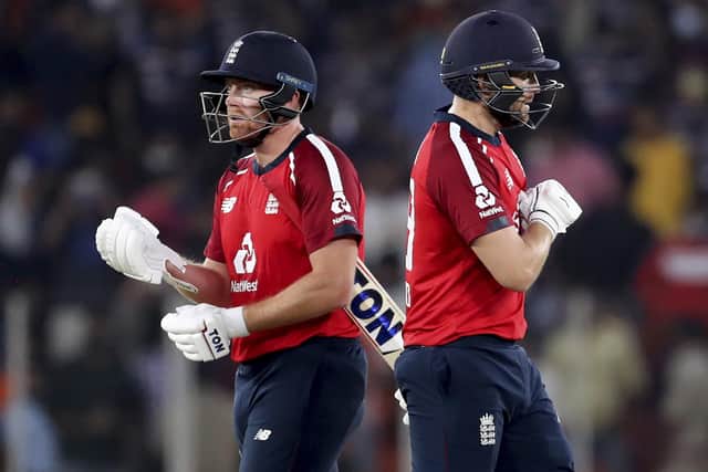 England's Jonny Bairstow, left, and Dawid Malan celebrate their win in the first Twenty20 cricket match between India and England at Narendra Modi Stadium in Ahmedabad. (AP Photo/Aijaz Rahi)