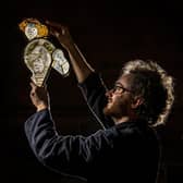 Tristram Cooke looks at the original 15th century medieval stained glass panel of St George in Thornhill Parish church near Dewsbury. The church is undergoing a project restoring the medieval stained glass windows by master glazier Jonathan Cooke. . Picture Tony Johnson