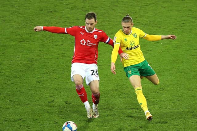 Barnsley's Michael Sollbauer (left) and Norwich City's Przemyslaw Placheta battle for the ball. Picture: Nigel French/PA