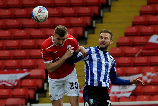 Owls star: Jordan Rhodes is is challenged by Barnsley's Michal Helik. Picture: Simon Hulme