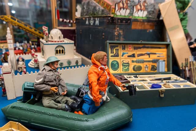 Pictured Alex Samuel, curator of the Ilkley Toy Museum, placing Action-man figures, in a mixed display. Image: James Hardisty