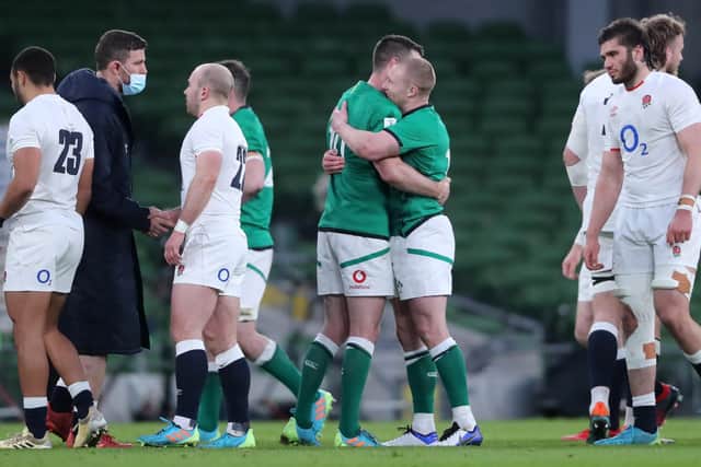 Winners and losers: England and Ireland players shake hands as Ireland celebrate their comprehensive victory. Picture: Niall Carson/PA Wire.