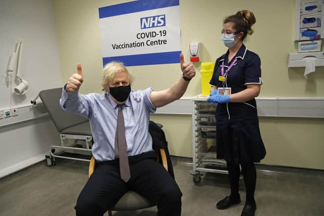 Prime Minister Boris Johnson gives thumbs up after receiving the first dose of AstraZeneca vaccine administered by nurse and Clinical Pod Lead, Lily Harrington at Westminster Bridge Vaccination Centre at St Thomas' Hospital in London. Picture: Frank Augstein/PA Wire