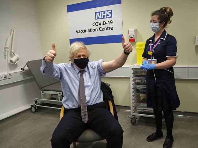 Prime Minister Boris Johnson gives thumbs up after receiving the first dose of AstraZeneca vaccine administered by nurse and Clinical Pod Lead, Lily Harrington at Westminster Bridge Vaccination Centre at St Thomas' Hospital in London. Picture: Frank Augstein/PA Wire