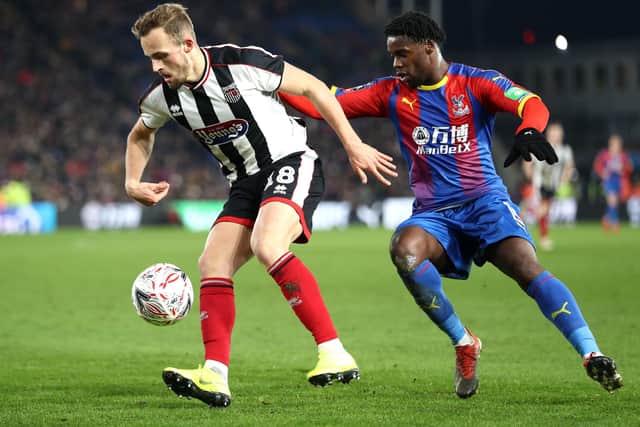 THAT WAS THEN: Grimsby's Charles Vernam comes under pressure from Crystal Palace's Jeffrey Schlupp during an FA Cup Third Round clash at Selhurst Park in January 2019. Picture: Bryn Lennon/Getty Images