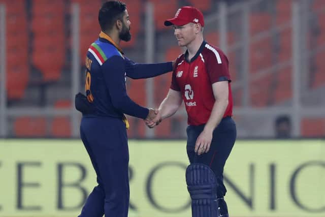 India's captain Virat Kohli, left, shakes hands with England's captain Eoin Morgan after India won the T20 Series in Ahmedabad on Saturday. Picture: AP/Ajit Solanki