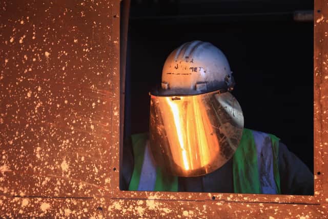 A worker tends to the furnace producing ferrotitanium during a visit to Tivac Alloys by UKIP leader Nigel Farage to see first hand how the global steel crisis is affecting small businesses on April 18, 2016. Pic by Getty Images.