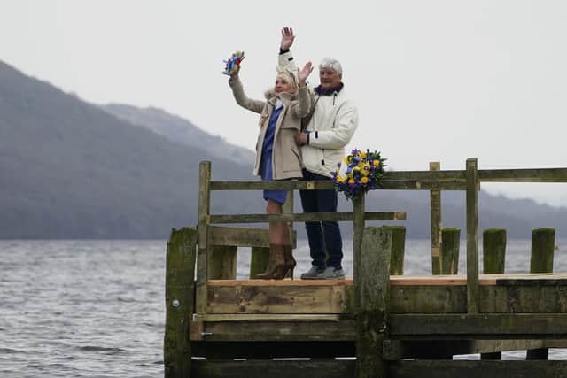 Gina Campbell and her partner, Brian Eastham, are pictured at Coniston Water in the Lake District after an RAF flypast to mark the 100th anniversary of the birth of her father, Donald Campbell. On January 4, 1967, Mr Campbell crashed his jet-powered boat, Bluebird K7, on Coniston Water while attempting to break his own world water speed record. (Photo by Christopher Furlong/Getty Images)