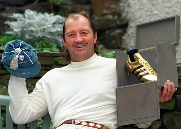 Frank Worthington pictured in 1998 at his Huddersfield home, with one of his England caps from  1973-74 and the  Golden Boot for top scorer in the first division in 1978-79  for Bolton Wanderers.