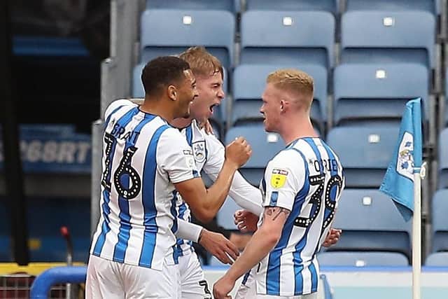 Staying up alone: Huddersfield players celebrate survival against West Bromwich behind closed doors.