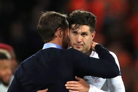 Back in the fold: England head coach Gareth Southgate embraces John Stones. Picture: PA