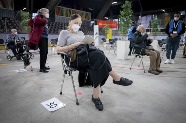 Anneliese Spies, 88 years old, waits for her husband after she receives an injection against the COVID-19 disease with the vaccine of Biontech/Pfizer at the Erika-Hess-Eisstadion vaccine center in Berlin, Germany in January (Kay Nietfeld/Pool vis AP)