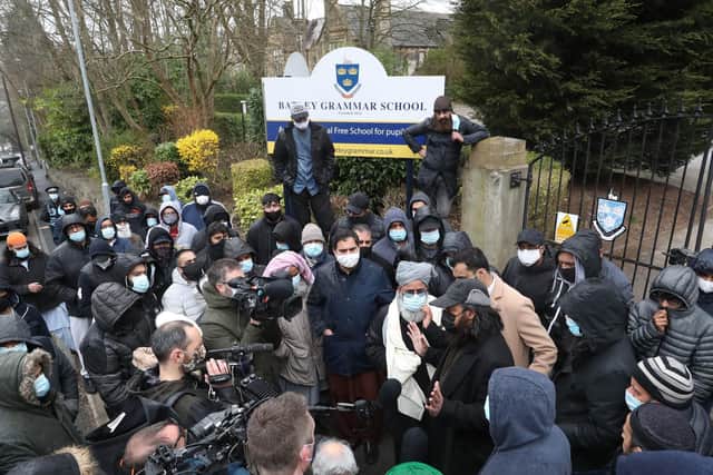 Protesters give a statement to members of the media outside Batley Grammar School in Batley, West Yorkshire, where a teacher has been suspended. Pic: PA