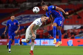 England's Dominic Calvert-Lewin heads the ball under pressure from San Marino's Dante Rossi.