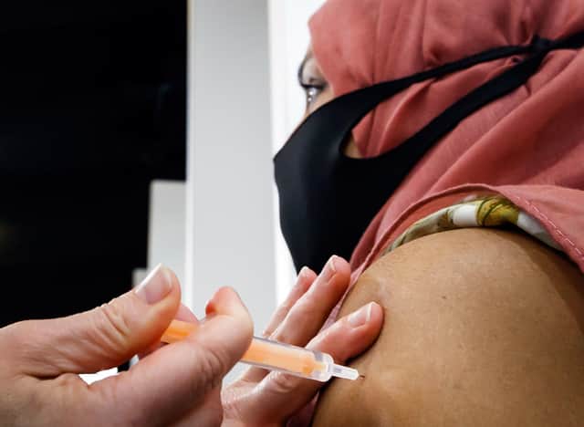 A woman receives an injection of the Oxford/AstraZeneca coronavirus vaccine at Elland Road vaccine centre in Leeds. Picture: Danny Lawson/PA Wire