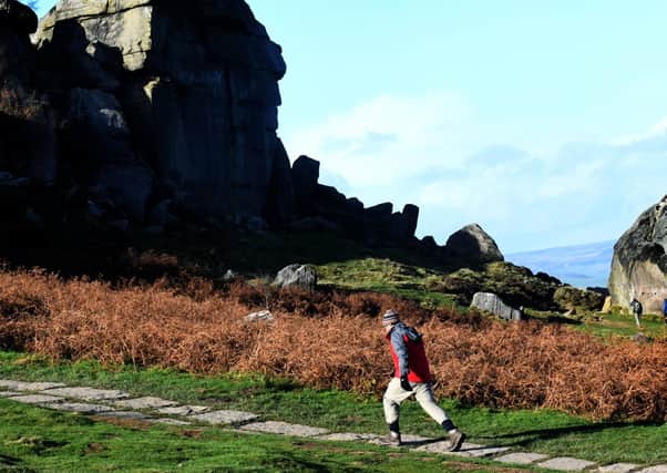 Visitors to the Cow and Calf rocks on Ilkley Moor. Picture: Gary Longbottom