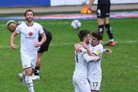 WINNING STRIKE: Daniel Harvie is congratulated by his teammates after scoring the only goal of the game between MK Dons and Doncaster Rovers. Picture: Getty Images.