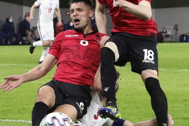 England's Harry Kane, bottom, fight for the ball with Albania's Berat Djimsiti, left, and Ardian Ismajli (AP Photo/Hektor Pustina)