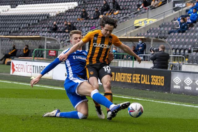 Hull City's George Honeyman tackled by Gillingham's Jack Tucker. (Picture: Tony Johnson)