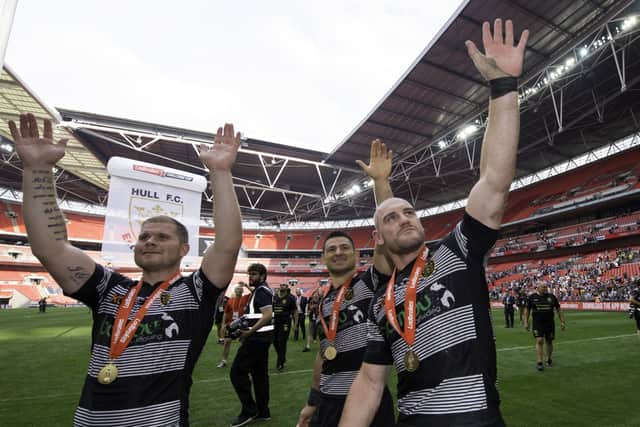GOOD OMEN: Danny Washbrook, Mark Minichiello and Gareth Ellis celebrate to the fans after their side's victory over Wigan in the 2017 Challenge Cup final. Picture: Allan McKenzie/SWpix.com