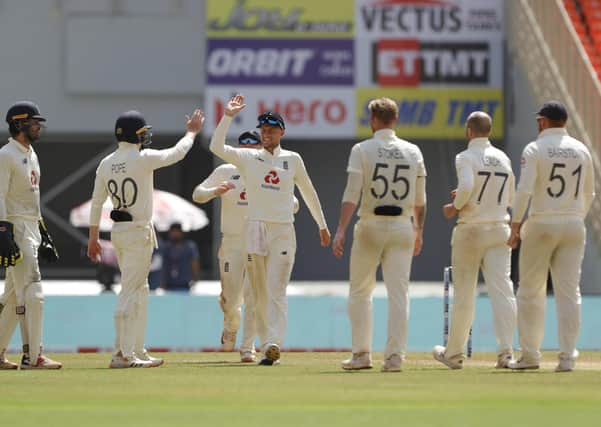 England's Jack Leach and Joe Root celebrate the wicket of Ravichandran Ashwin on day one of the fourth Test match in Ahmedabad. Picture: Saikat Das/Sportzpics for BCCI (via ECB).