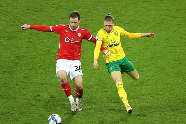 Barnsley's Michael Sollbauer (left) and Norwich City's Przemyslaw Placheta battle for the ball (Picture: PA)