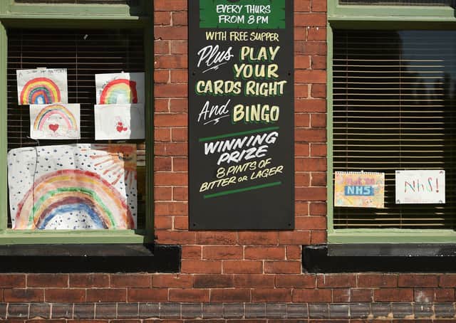 Posters depicting the colours of a rainbow, being used as symbols of hope during the COVID-19 pandemic, and paying tribute to Britain's NHS  workers, are seen in the window of a closed-down pub in  Pontefract.