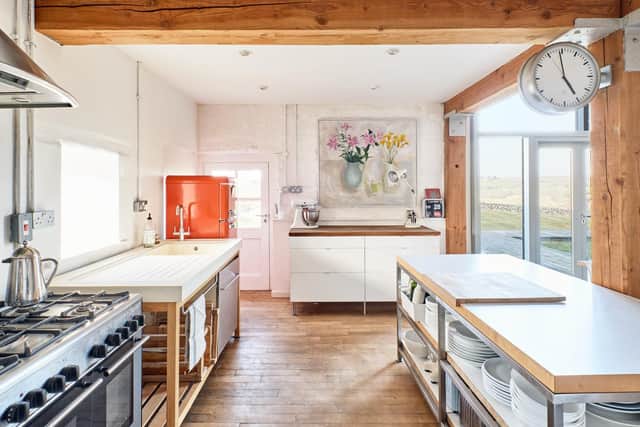 The kitchen with free-standing uinits and pops of colour from the fridge and art work.