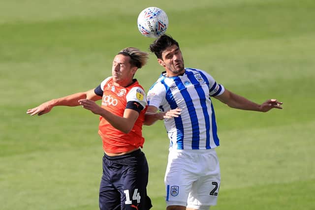 Luton Town's Harry Cornick (left) and Huddersfield Town's Christopher Schindler battle for the ball during a Championship game back in July (Picture: PA)