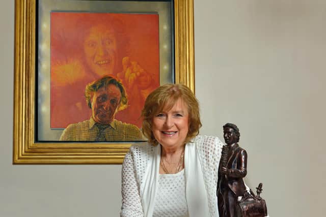 Lady Anne Dodd with a painting depicting her late husband by David Cobley. Picture: Ron Davies.