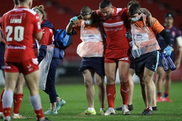 Hull KR's Elliot Minchella is helped off in last night's game against St Helens (PA)