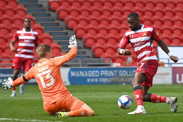 Rare chance: Doncaster Rovers’ Omar Bogle attempts to take the ball round Charlton’s goalkeeper Ben Amos. Picture: Andrew Roe/AHPIX LTD