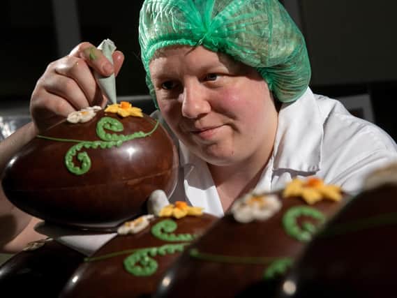 Chocolatier Toni Hughes decorates a chocolate egg for Bettys' Easter range. Staff at the Harrogate business have reported the busiest ever run-in to the Easter weekend. (Photo: Bruce Rollinson).