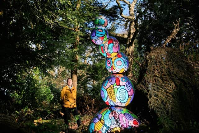 Kat Trinder, who works on the estate, looks at an art installation in Wentworth Castle Gardens, near Barnsley. (PA).