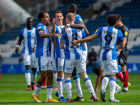 Huddersfield Town goalscorer Lewis O'Brien is congratulated by his team-mates after putting the hosts in front against Brentford. Picture: Bruce Rollinson.