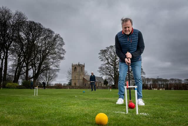 Beverley & East Riding Croquet Club member Stanley Smith, practising on the lawns with a backdrop of St Peter's Church. Image: James Hardisty