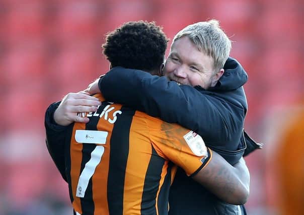 Hull City manager Grant McCann (right) celebrates victory with Mallik Wilks (left). Pictures: PA.