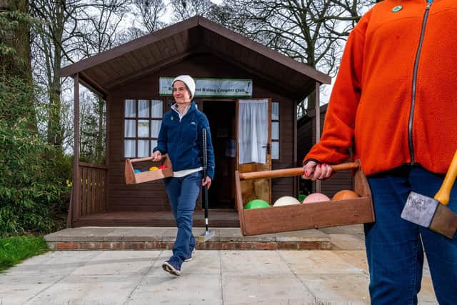 Debbie James, Club Secretary, of Beverley & East Riding Croquet Club, walking out of their small clubhouse in preparation for her warm-up game. Image: James Hardisty