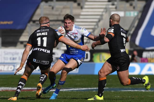 TOUGH GOING: Leeds Rhinos' Liam Sutcliffe runs into Castleford Tigers' Oliver Holmes and Paul McShane. 
Picture: Jonathan Gawthorpe