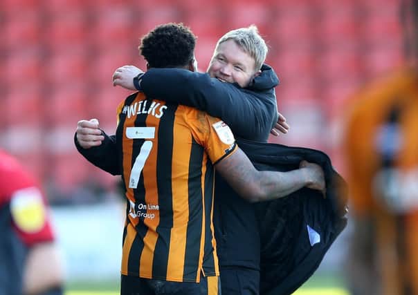 Joy: Hull City manager Grant McCann celebrates victory with Mallik Wilks. Picture: PA