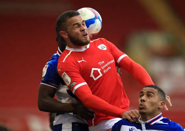 Impact: Barnsley's Carlton Morris, battling for the ball with Reading's Andy Yiadom and Andy Rinomhota, shone after coming off the bench.