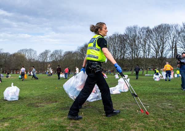 Police help clear litter in a Leeds park after the easing of the lockdown.