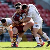 In for a steal?: Huddersfield Giants' Sam Wood is tackled by Catalans  during the Betfred Super League match at the Totally Wicked Stadium, St Helens. Picture: Richard Sellers/PA