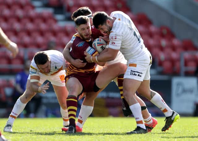 In for a steal?: Huddersfield Giants' Sam Wood is tackled by Catalans  during the Betfred Super League match at the Totally Wicked Stadium, St Helens. Picture: Richard Sellers/PA