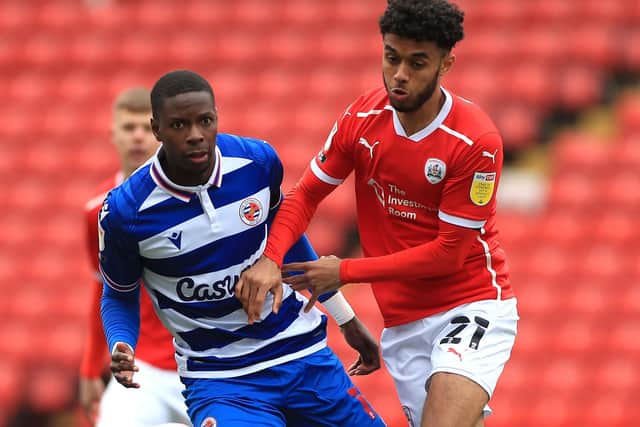 Battle: Reading's Lucas Joao is challenged by Barnsley's Romal Palmer. Pictures: PA