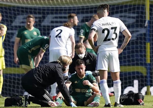Injury: George Baldock is treated during the Premier League match at Elland Road. Picture: Andrew Yates/Sportimage