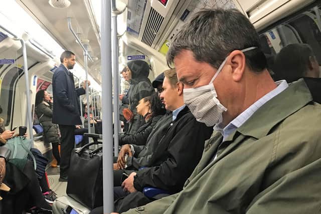 A man on the Jubilee line of the London Underground tube network wearing a protective facemask. Photo: Kirsty O'Connor/ PA Wire