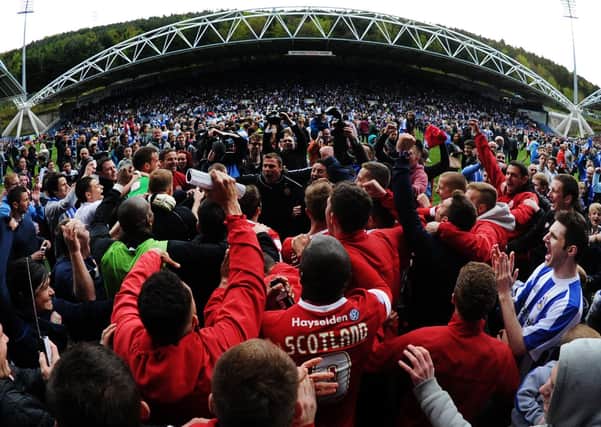 A day to remember: 
Huddersfield Town and Barnsley fans celebrate after hearing the Peterborough result which kept both clubs safe.