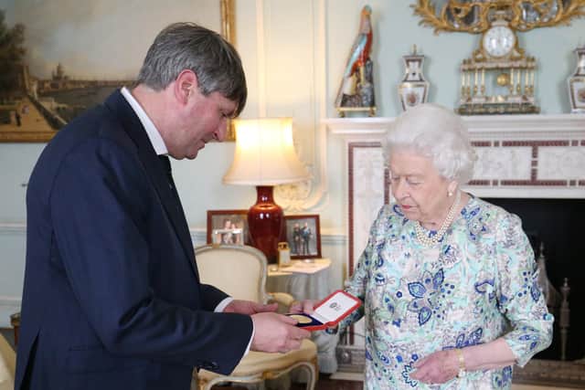 Queen Elizabeth presents Simon Armitage with the Queen's Gold Medal for Poetry upon his appointment as Poet Laureate during an audience at Buckingham Palace, London. Credit: Jonathan Brady/PA Wire.
