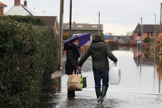 Local residents in floodwater in East Cowick, Yorkshire. Photo: Danny Lawson/PA Wire